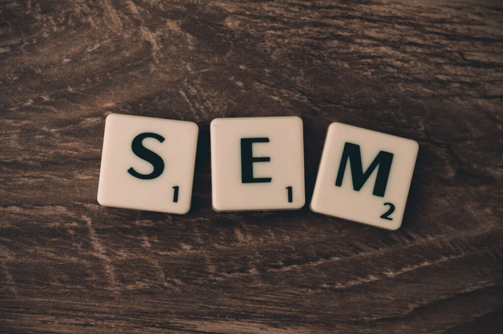 Crafting Captivating Headlines: Your awesome post title goes here Wooden background with letter tiles spelling SEM, representing search engine marketing.
