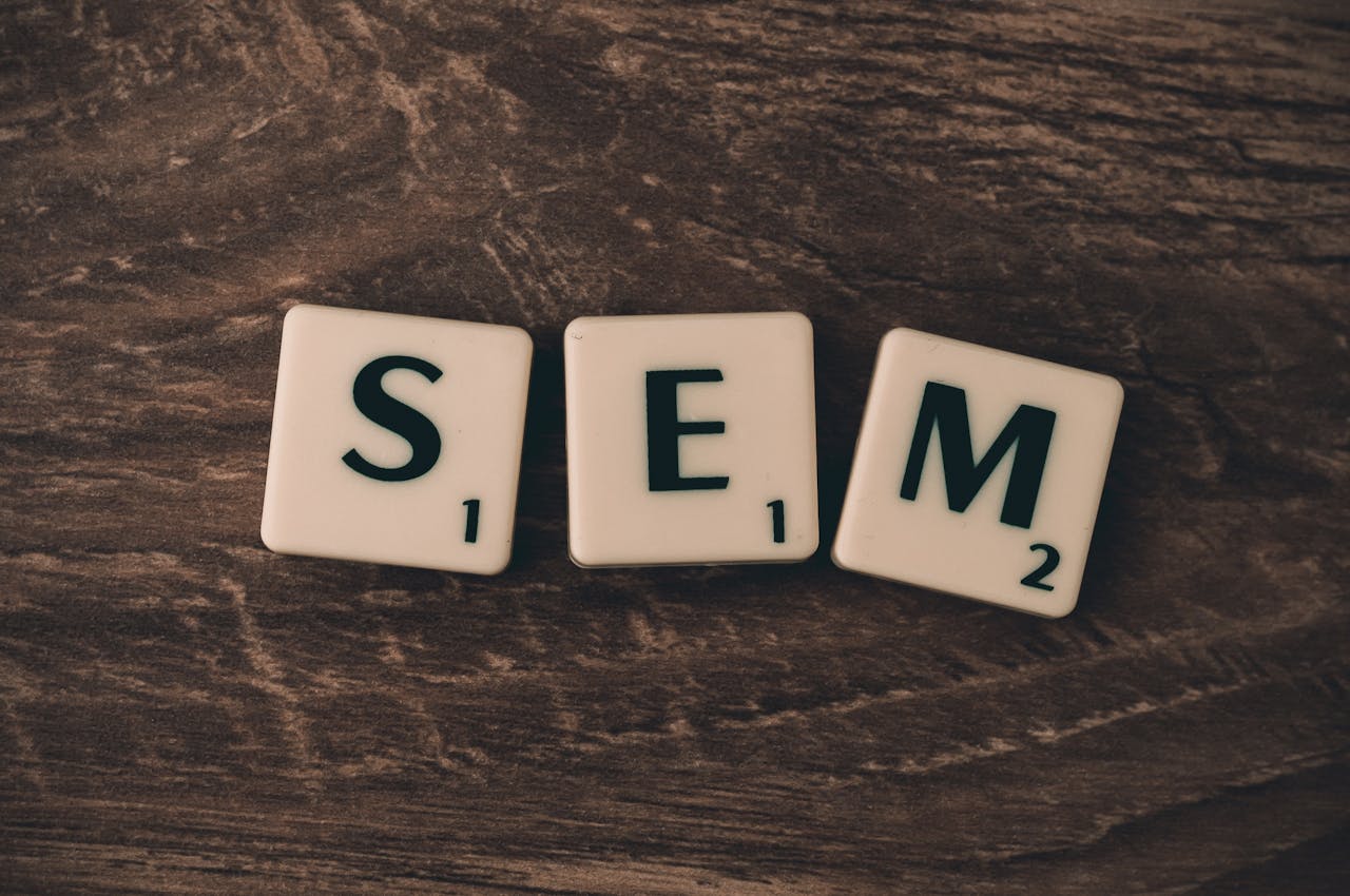 Crafting Captivating Headlines: Your awesome post title goes here Wooden background with letter tiles spelling SEM, representing search engine marketing.